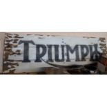 A painted wood 'Triumph' sign