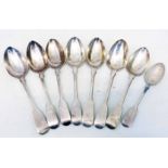 Seven antique London silver fiddle pattern dessert spoons and a teaspoon