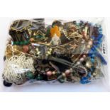 A bag containing a quantity of assorted costume jewellery