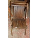 A vintage stained wood framed slatted folding chair bearing MGM stamp to base