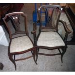 An Edwardian inlaid and strung stained wood framed elbow chair with decorative splat and upholstered