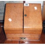 An 11 1/2" late Victorian polished oak slope fronted stationery cabinet with drawer under