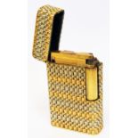 A yellow and white metal cigarette lighter with machined finish and stamped 750 to base