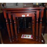 A nest of three Beresford & Hicks polished mixed wood tea tables, set on slender turned and reeded