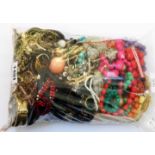 A bag containing a quantity of assorted costume jewellery