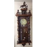 A 4' 7" late 19th Century stained walnut cased Vienna style regulator wall clock with ornate