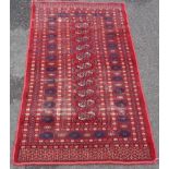 A Bokhara rug with single row of guls within multi repeat border on red ground - 4' 11" X 3' (