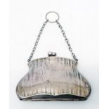 A white metal evening bag pattern purse with fitted interior and suspender chain