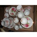 A box containing a Royal Albert American Beauty pattern part tea set and further rose pattern