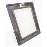 A silver fronted photograph frame with upholstered easel back - to take 8" X 6" - Birmingham 1904