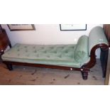 A 6' 4" 19th Century polished oak day bed with decorative scroll end, bolster and button back swab