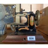 A vintage Diana tinplate toy sewing machine - seized