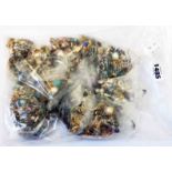 A bag containing a large collection of costume jewellery ear-rings, etc.