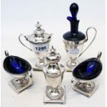 A five piece silver plated condiment set in the Georgian style with blue glass liners, beaded