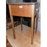 A 20th Century oak lift-top work table carcass, set on square tapered legs