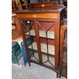 A 30 1/4" Edwardian mahogany display cabinet with stencilled decoration and material lined shelves