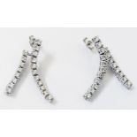 A pair of marked 750 white metal ear-rings, each with two articulated drop set with nineteen