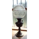 A brass table oil lamp with acid etched globe