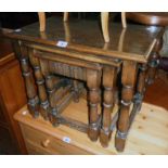 A nest of three 20th Century polished oak tea tables, set on turned supports