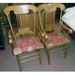 Two similar American stained black walnut framed gingerbread spindle back elbow chairs with matching