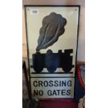 A modern reproduction painted cast iron Crossing, No Gates sign