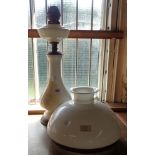 A milk glass oil lamp and shade