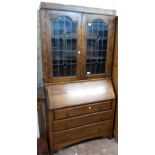 A 3' 5" early 20th Century oak bureau bookcase with leaded glass top (cornice a/f), over part fitted