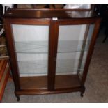 A 35 1/2" retro Swedish stained mixed wood display cabinet with glass shelves enclosed by a pair