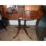 A 33" reproduction walnut drop-leaf centre table with moulded edge, turned supports and quatrefoil