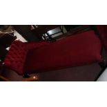 A 5' 7" reproduction Victorian style chaise longue with red button back velour upholstery set on