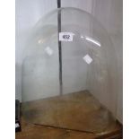 An antique glass clock dome - 16" high X 15 1/4" X 6 3/4"