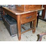 A 5' 9 1/2" antique stained pine baker's table with opposing deep drawers and iron drop handles, set