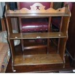 A 25" early 20th Century stained oak three shelf wall mounted unit with shaped and pegged standard