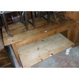 A 5' 1 1/2" antique waxed pine kitchen table with triple plank top and blind frieze drawer, set on