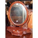 A Victorian stained wood platform dressing table mirror with oval plate, pierced scroll supports and