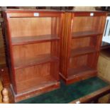 A pair of 20 1/2" reproduction mahogany three shelf open bookcases