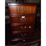 A 17" reproduction mahogany four drawer bedside chest, set on bracket feet