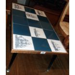 A 31 1/2" retro coffee table with maritime themed tile inset top, set on slender ebonised and