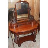 A 3' 5" Victorian mahogany duchess dressing table with swing mirror, pierced scroll supports,