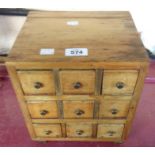 A small vintage pine nine drawer chest