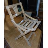 A vintage child's folding chair with slatted seat panel