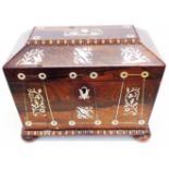An antique rosewood sarcophagus tea caddy with inlaid mother-of-pearl decoration, set on bun
