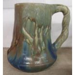 An early 20th Century Nils de Barck Japonist pottery mug with moulded tree design and metallic