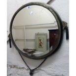 A 22" diameter Art Deco brass metal framed bevelled wall mirror, with flanking decorative tassels