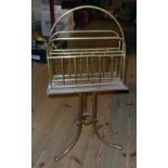 An Edwardian brass and walnut revolving magazine rack standard, set on tripod base