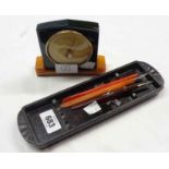 A vintage bakelite pen tray, three dip pens and an Art Deco Taylor Baroguide bakelite desk