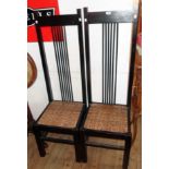 A set of four ebonised wood framed high stick back dining chairs with woven cane geometric seat