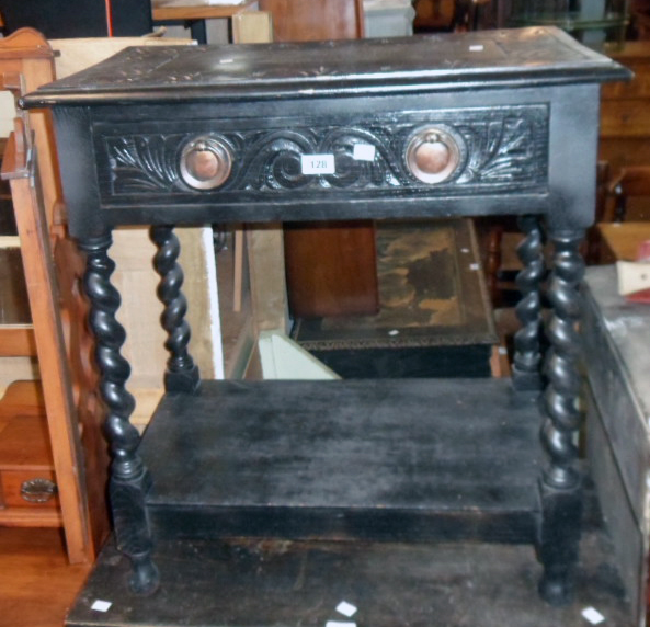 A 27" ebonised and carved wood side table with copper back plate handles, barley twist supports