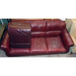 A 7' 3" modern three seater settee upholstered in oxblood coloured leather - sold with an associated