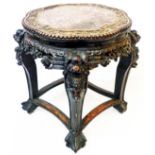 A 17 1/2" diameter antique Chinese stained and profusely carved padouk low table with shaped